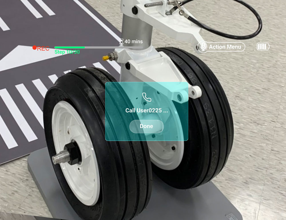 a_man_repairs_a_model_of_an_aircraft_landing_gear_according_to_the_instructions_of_a_remote_expert